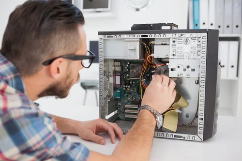 Computer engineer working on broken console in his office