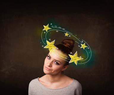 Young girl with yellow stars circleing around her head illustration